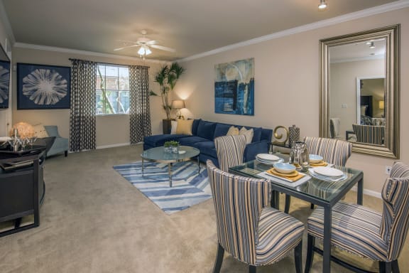 a living room with a couch and a table at Loreto & Palacio Apartments, Las Vegas, Nevada