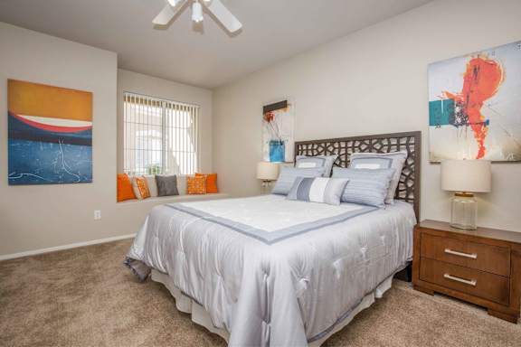a bedroom with a white bed and a ceiling fan at The Belmont by Picerne, Las Vegas, Nevada