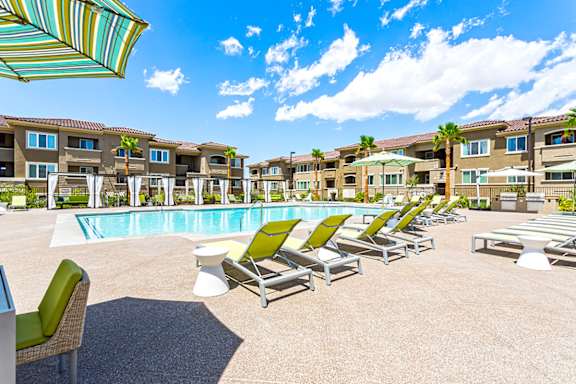 a swimming pool with green lounge chairs and buildings in the background t The View at Horizon Ridge, Nevada, 89012