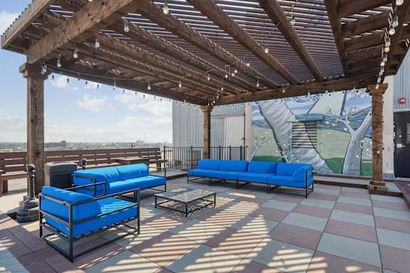 Rooftop patio with blue couches at 3200 Main Lofts | Deep Ellum Lofts in Dallas, TX