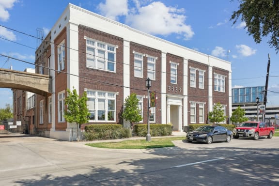 a large brick building with cars parked in front of it