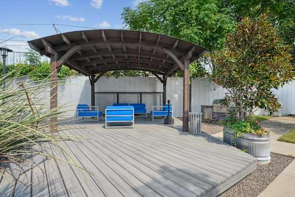 3333 Elm Street patio with shaded seating  with blue chairs | Deep Ellum Lofts in Dallas, TX