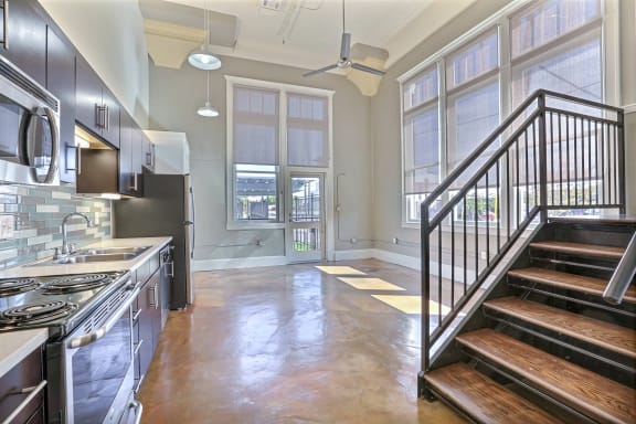 a kitchen with a stove top oven next to a doorway