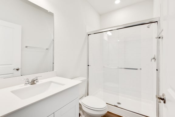 a bathroom with a toilet sink and shower