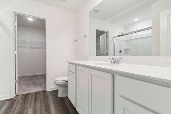 A white bathroom with a toilet and a sink.