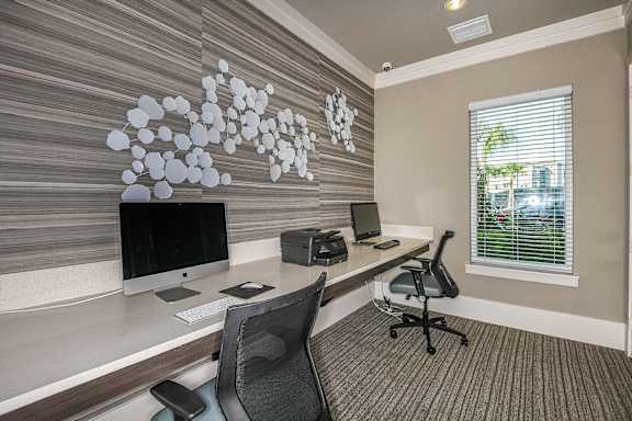 Business center with two computers at Dunedin Commons apartments in Dunedin FL
