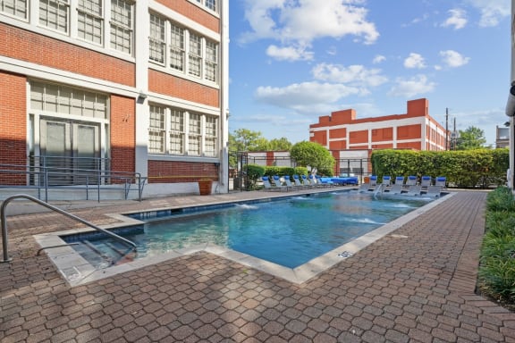 a swimming pool with a building in the background