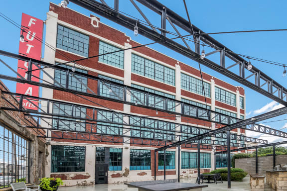 a large brick building with a large red sign on the side of it