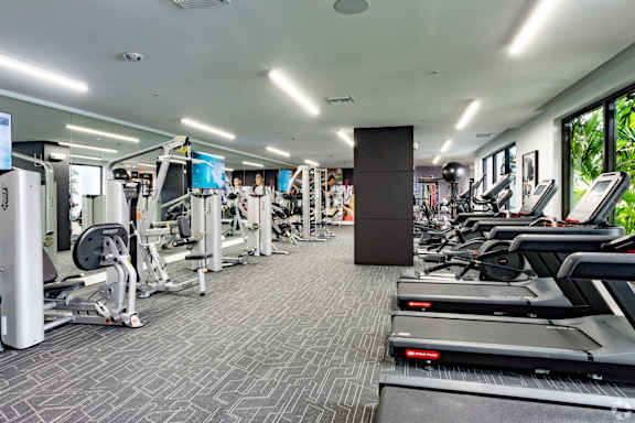Our state-of-the-art fitness center with treadmills, free weights, and exercise machines at Hollywood Heights on the Boulevard Luxury Apartments in Hollywood, FL