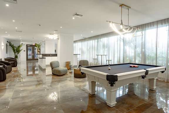 A pool table in our social club  with plush seating at Hollywood Heights on the Boulevard Luxury Apartments in Hollywood, FL