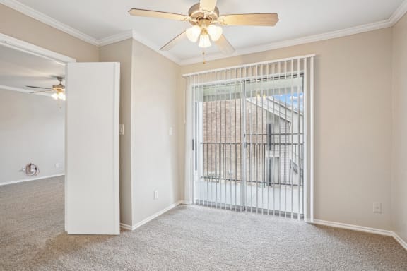 Unfurnished A4 floor plan living room with a door leading to balcony and a ceiling fan Noel on The Parkway in Dallas, TX