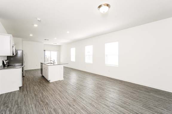 a family living room with hardwood floor and natural light