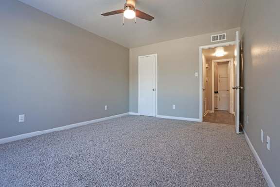 A bedroom with a ceiling fan and closet at Orleans Square in Shreveport, LA