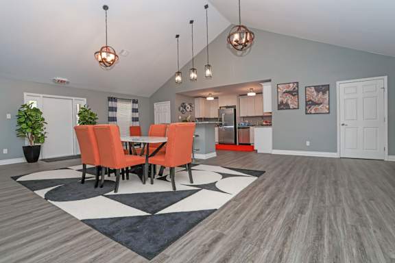 Vibrant chairs surround a table in a modern clubhouse at Orleans Square in Shreveport, LA