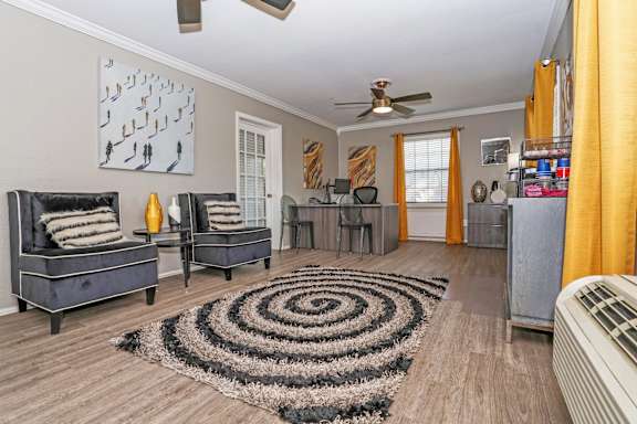 A leasing office with a black and white rug and a ceiling fan at Orleans Square in Shreveport, LA