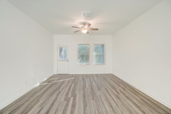 dining area with a ceiling fan and wood floors