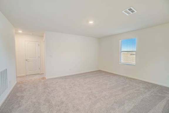 family room with carpet flloor, white walls and a window