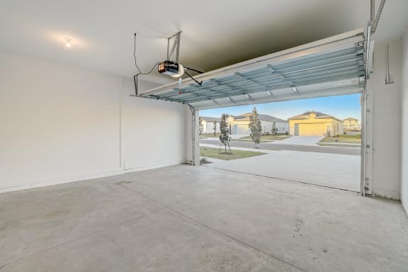 the interior of spacious garage with an open garage door