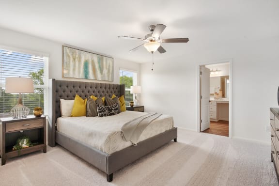 a bedroom with a bed and a ceiling fan