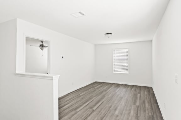 a loft bedroom with hardwood floors and white walls