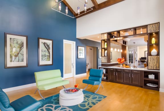 Clubhouse lounge area with colorful seats and bowl of candy in Wynnfield Lakes apartments in Jacksonville, FL