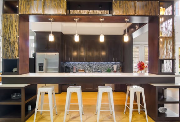 Clubhouse kitchen with coffee maker and stools in Wynnfield Lakes apartments in Jacksonville, FL