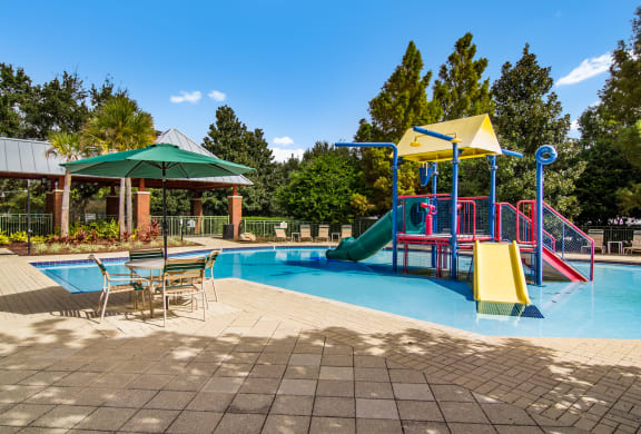 Children's splash park with colorful slides in Wynnfield Lakes apartments in Jacksonville, FL