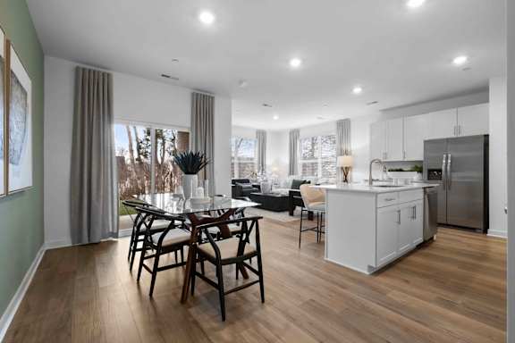 A modern kitchen with a dining table and chairs.