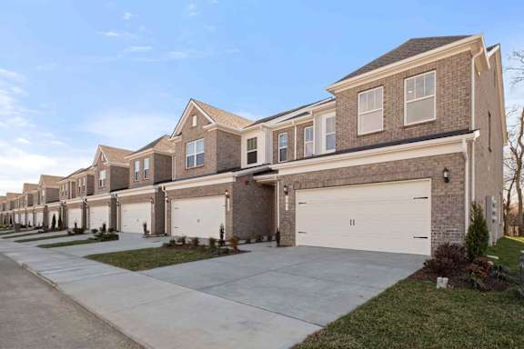 A row of houses with garages in front.