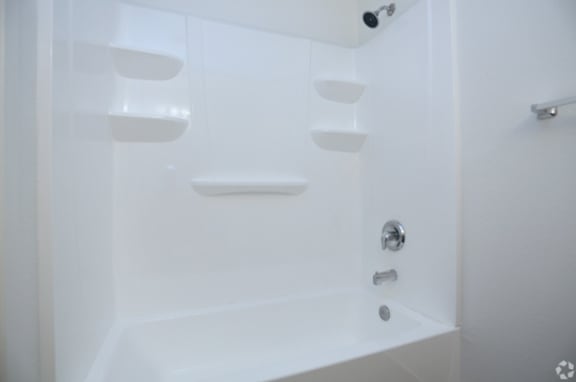 a bathroom with a white bathtub and a white shower curtain