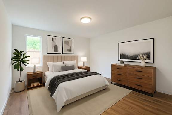 A bedroom with a large bed, a nightstand, and a dresser.