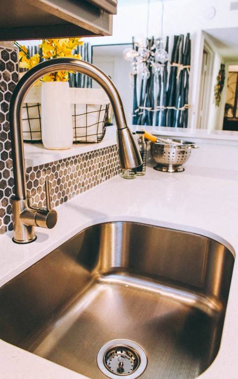 Kitchen sink with modern pull down faucet at Skyline at Barton Creek Apartments, Austin, TX 78758