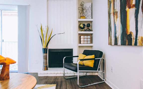 Modern living room with fireplace and builtin shelving at Skyline at Barton Creek Apartments, Texas