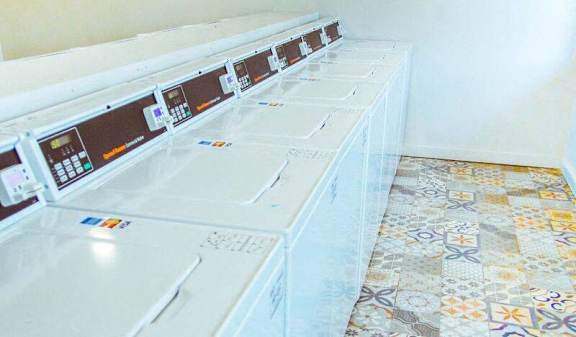 Laundry facility with front load washers and folding counter at Skyline at Barton Creek Apartments, Austin, TX