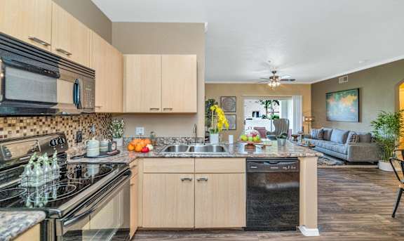 the view of a kitchen and living room with a couch at Montage at Pecos Ranch Apartments, Chandler, 85286