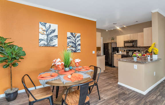 a dining area with a table and chairs and a kitchen in the background at Montage at Pecos Ranch Apartments, Chandler, AZ, 85286