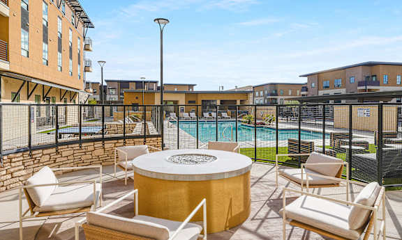 Poolside area with a hot tub and chairs at Solace at Ballpark Village, Goodyear