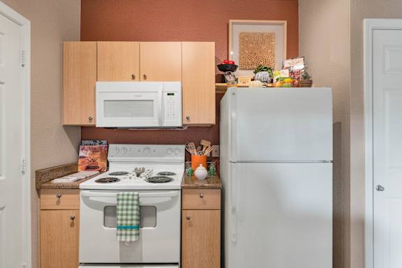 a kitchen with a stove microwave and refrigerator at Montage at Pecos Ranch Apartments, Chandler