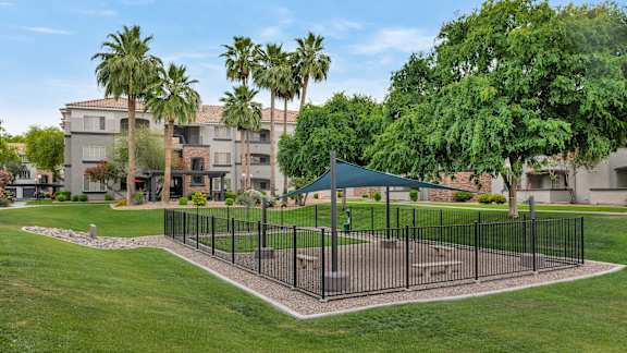 a fenced in area with a pavilion in the middle of a park at Montage at Pecos Ranch Apartments, Chandler, AZ