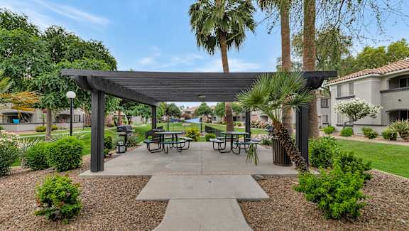 a picnic area with tables and awnings in a courtyard at Montage at Pecos Ranch Apartments, Chandler, 85286