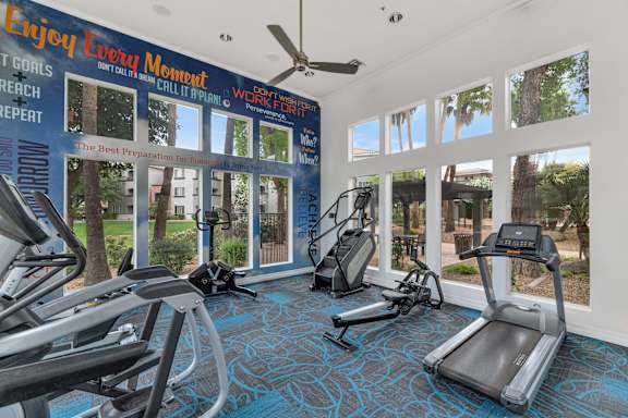 gym with cardio equipment and windows at the resort at longboat key club at Montage at Pecos Ranch Apartments, Arizona, 85286