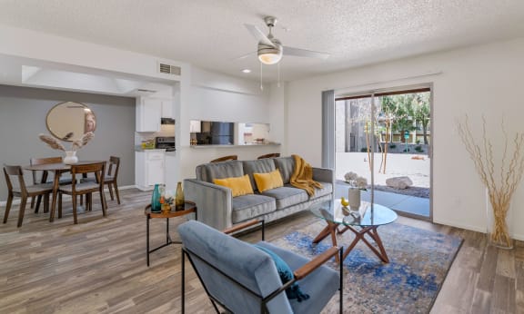 an open living room and dining room with a sliding glass door to a patio  at Glen Brae, Glendale, Arizona