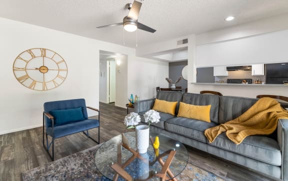 a living room with a large clock on the wall and a couch  at Glen Brae, Glendale, AZ