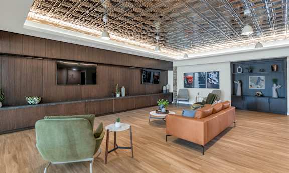 Community living room with TV at Solace at Ballpark Village, Goodyear, AZ