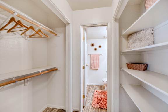 A white closet with a doorway leading to a bathroom at Reflections at Red Mountain Apartments, Mesa 85213