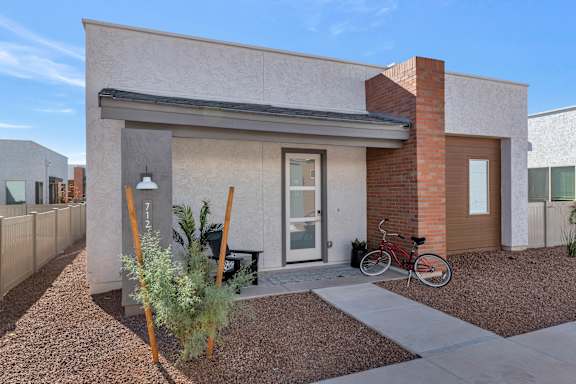 A modern house with a bicycle parked in front.