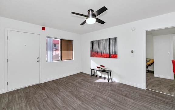 A room with a ceiling fan and a painting on the wall at Urban WalkApartments on 6th Avenue, Phoenix, AZ