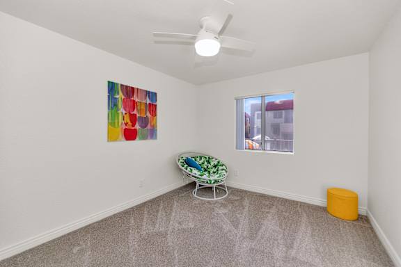 A room with a painting on the wall and a green and white chair at Urban WalkApartments on 6th Avenue, Phoenix, Arizona
