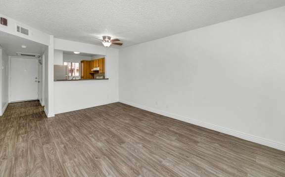 A room with wooden flooring and a ceiling fan at Urban WalkApartments on 6th Avenue, Phoenix, AZ