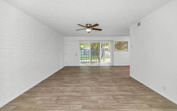 A room with a ceiling fan and wooden flooring at The Phoenix Apartments on 6th Avenue, Phoenix